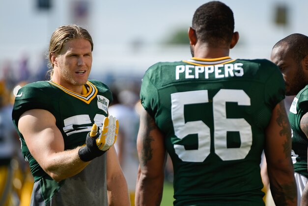 Jul 30, 2014; Green Bay, WI, USA; Green Bay Packer linebacker Clay Matthews (left) talks to defensive end Julius Peppers during training camp at Ray Nitschke Field. Mandatory Credit: Benny Sieu-USA TODAY Sports
