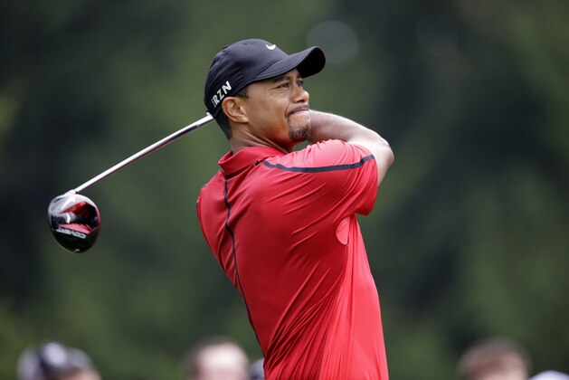Tiger Woods watches his drive on the fourth hole during the final round of the Bridgestone Invitational golf tournament Sunday, Aug. 3, 2014, at Firestone Country Club in Akron, Ohio. (AP Photo/Mark Duncan)