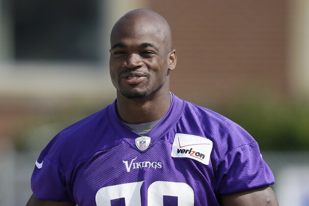 Minnesota Vikings running back Adrian Peterson walks to the field before an NFL football training camp practice, Saturday, Aug. 2, 2014, in Mankato, Minn. (AP Photo/Charlie Neibergall)