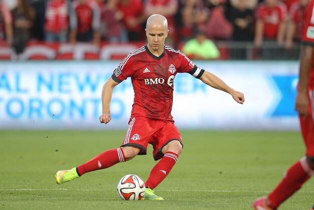 Jul 16, 2014; Toronto, Ontario, CAN; Toronto FC midfielder Michael Bradley (4) moves the ball during their match against the Vancouver Whitecaps at BMO Field. The FC tied the Whitecaps 1-1. Mandatory Credit: Tom Szczerbowski-USA TODAY Sports