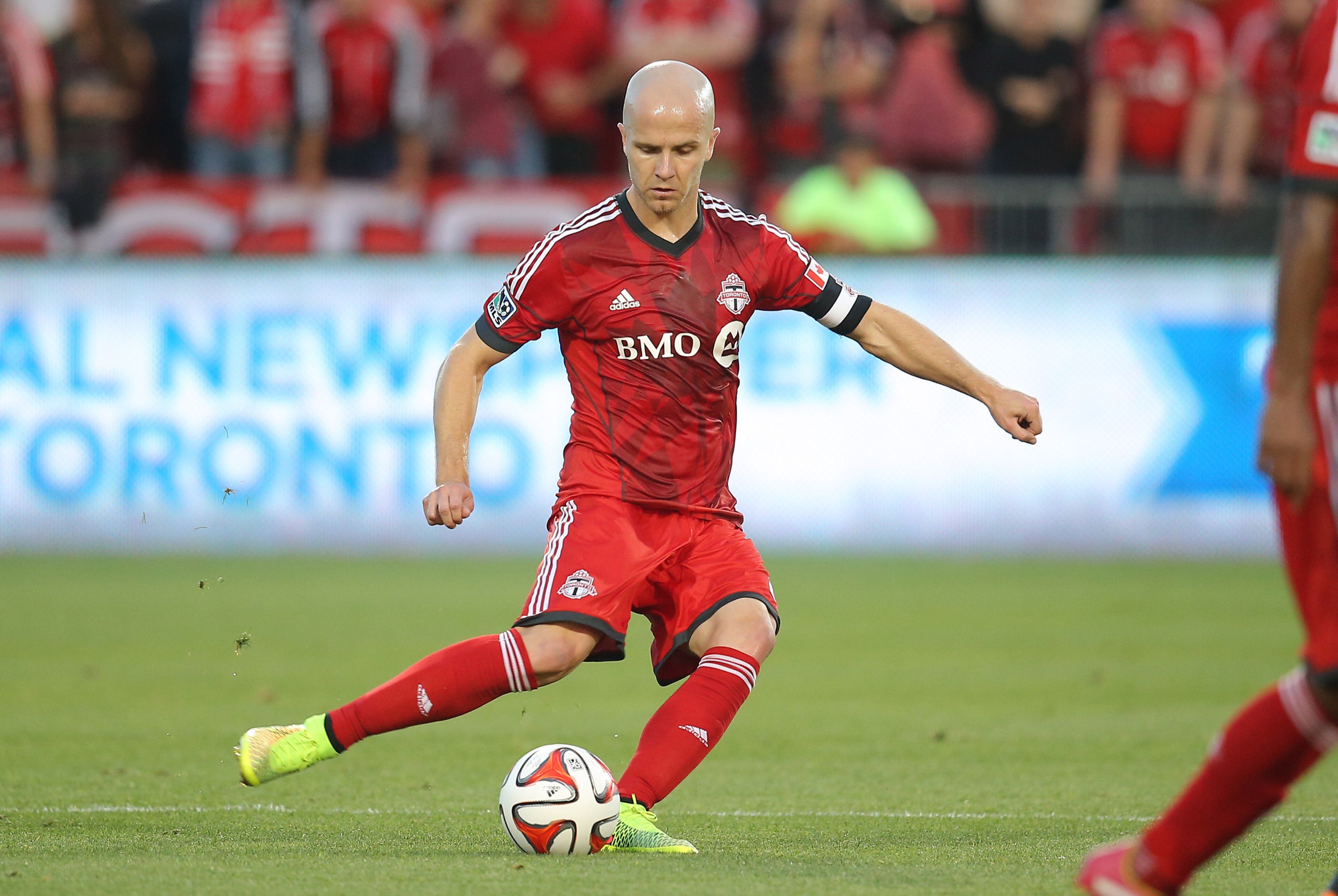 Jul 16, 2014; Toronto, Ontario, CAN; Toronto FC midfielder Michael Bradley (4) moves the ball during their match against the Vancouver Whitecaps at BMO Field. The FC tied the Whitecaps 1-1. Mandatory Credit: Tom Szczerbowski-USA TODAY Sports