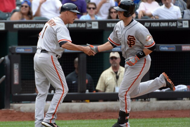 Aug 3, 2014; New York, NY, USA; San Francisco Giants catcher Buster Posey (28)  is greeted by San Francisco Giants third base coach Tim Flannery (1) after hitting a two run home run during the seventh inning against the New York Mets at Citi Field. Mandatory Credit: Robert Deutsch-USA TODAY Sports