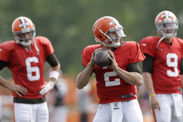 Cleveland Browns quarterback Johnny Manziel (2) gets ready to throw as quarterbacks Brian Hoyer (6) and Connor Shaw (9) watch during practice at the NFL football team's training camp Tuesday, Aug. 5, 2014, in Berea, Ohio. (AP Photo/Tony Dejak)