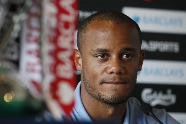 Manchester City's captain Vincent Kompany attends a pre-match press conference for the Barclays Asia Trophy in Hong Kong Tuesday, July 23, 2013. The matches will be held in Hong Kong July 24 and 27.  (AP Photo/Kin Cheung)