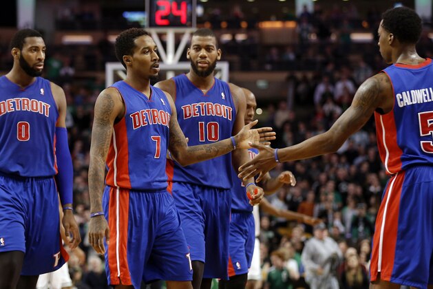Dec 18, 2013; Boston, MA, USA; Detroit Pistons point guard Brandon Jennings (7) is congratulated after hitting a three point shot by teammate shooting guard Kentavious Caldwell-Pope (5) as center Andre Drummond (0) and power forward Greg Monroe (10) look on during the fourth quarter of Detroit's 107-106 win over the Boston Celtics at TD Garden. Mandatory Credit: Winslow Townson-USA TODAY Sports