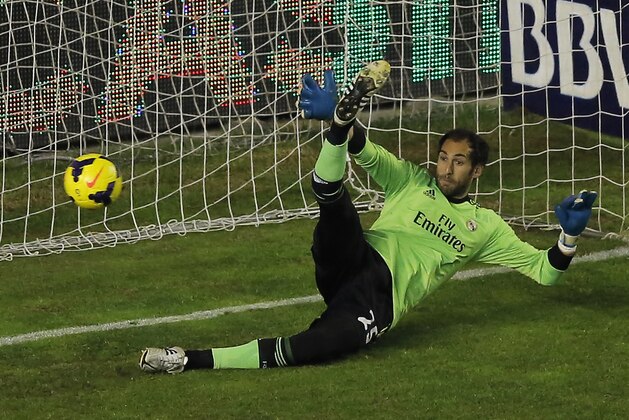 Real Madrid's goalkeeper Diego Lopez, tries to stop Rayo Vallecano's Jonathan Viera's penalty kick during a Spanish La Liga soccer match between Real Madrid and Rayo Vallecano at the Vallecas stadium in Madrid, Spain, Saturday, Nov. 2, 2013. (AP Photo/Andres Kudacki)