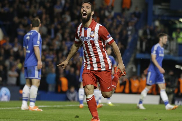 Atletico's Arda Turan celebrates after scoring his soda's 3rd goal during the Champions League semifinal second leg soccer match between Chelsea and Atletico Madrid at Stamford Bridge Stadium in London Wednesday, April 30, 2014. (AP Photo/Kirsty Wigglesworth)