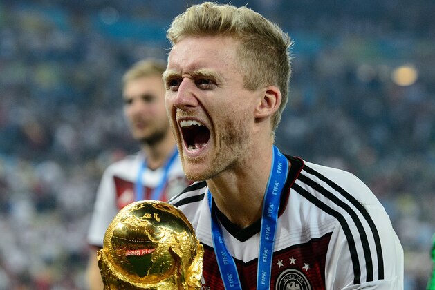 RIO DE JANEIRO, BRAZIL - JULY 13: Andre Schuerrle celebrates with the World Cup trophy after defeating Argentina 1-0 in extra time during the 2014 FIFA World Cup Brazil Final match between Germany and Argentina at Maracana on July 13, 2014 in Rio de Janeiro, Brazil. (Photo by Matthias Hangst/Getty Images) RIO DE JANEIRO, BRAZIL - JULY 13: Andre Schuerrle celebrates with the World Cup trophy after defeating Argentina 1-0 in extra time during the 2014 FIFA World Cup Brazil Final match between Germany and Argentina at Maracana on July 13, 2014 in Rio de Janeiro, Brazil. (Photo by Matthias Hangst/Getty Images)