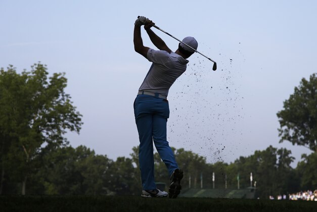 Rory McIlroy, of Northern Ireland, watches his tee shot on the 11th hole during a practice round for the PGA Championship golf tournament at Valhalla Golf Club on Wednesday, Aug. 6, 2014, in Louisville, Ky. The tournament is set to begin on Thursday. (AP Photo/John Locher)