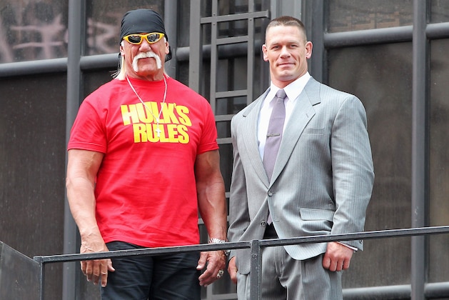 This image released by Starpix shows professional wresting personalities Hulk Hogan, left, and John Cena on top of the The Hard Rock Cafe during a news conference for Wrestlemania 30 on Tuesday, April 1, 2014 in New York. Wrestlemania 30 will be held on Sunday, April 6 in New Orleans .  (AP Photo/Starpix, Dave Allocca)