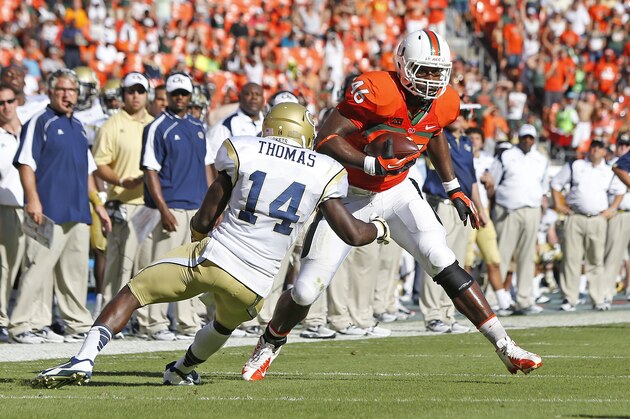 MIAMI GARDENS, FL - OCTOBER 5: Clive Walford #46 of the Miami Hurricanes runs with the ball while being defended by Jemea Thomas #14 of the Georgia Tech Yellow Jackets on October 5, 2013 at Sun Life Stadium in Miami Gardens, Florida. (Photo by Joel Auerbach/Getty Images)