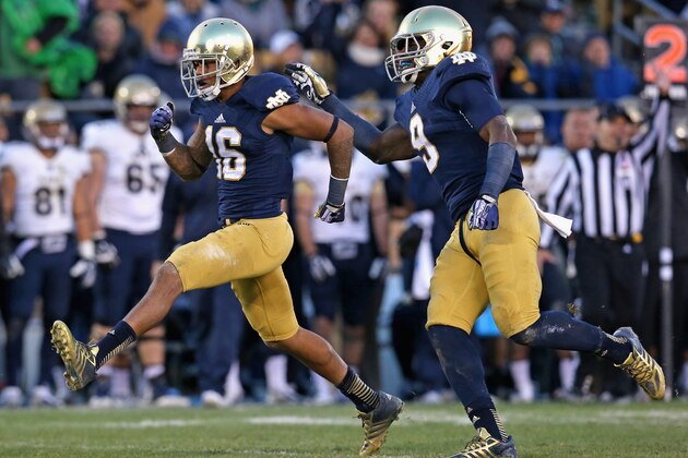 SOUTH BEND, IN - NOVEMBER 02:  Eilar Hardy #16 (L) and Jaylon Smith #9 of the Notre Dame Fighting Irish celebrate a sack against the Navy Midshipmen at Notre Dame Stadium on November 2, 2013 in South Bend, Indiana. Notre Dame defeated Navy 38-34.  (Photo by Jonathan Daniel/Getty Images)