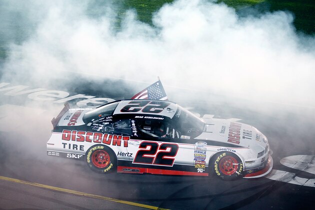 NEWTON, IA - AUGUST 02:  Brad Keselowski, driver of the #22 Discount Tire Ford, celebrates after winning the NASCAR Nationwide Series U.S. Cellular 250 at Iowa Speedway on August 2, 2014 in Newton, Iowa.  (Photo by Brian Lawdermilk/Getty Images)