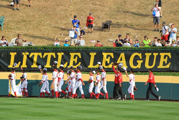 Aug 25, 2013; Williamsport, PA, USA; Japan players celebrate after defeating California (West) 6-4 in the Little League World Series championship game at Lamade Stadium. Mandatory Credit: Matthew O'Haren-USA TODAY Sports