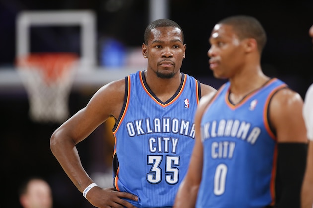 Oklahoma City Thunder small forward Kevin Durant looks on behind point guard Russell Westbrook against the Los Angeles Lakers during the first half of an NBA basketball game in Los Angeles, Sunday, March 9, 2014. (AP Photo/Danny Moloshok)