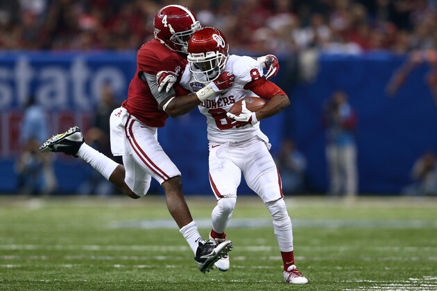 NEW ORLEANS, LA - JANUARY 02:  Jalen Saunders #8 of the Oklahoma Sooners is tackled by Eddie Jackson #4 of the Alabama Crimson Tide during the Allstate Sugar Bowl at the Mercedes-Benz Superdome on January 2, 2014 in New Orleans, Louisiana.  (Photo by Streeter Lecka/Getty Images)