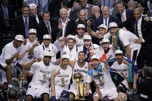 The San Antonio Spurs pose for a photo after Game 5 of the NBA basketball finals against the Miami Heat on Sunday, June 15, 2014, in San Antonio. The Spurs won the NBA championship 104-87. (AP Photo/Tony Gutierrez)