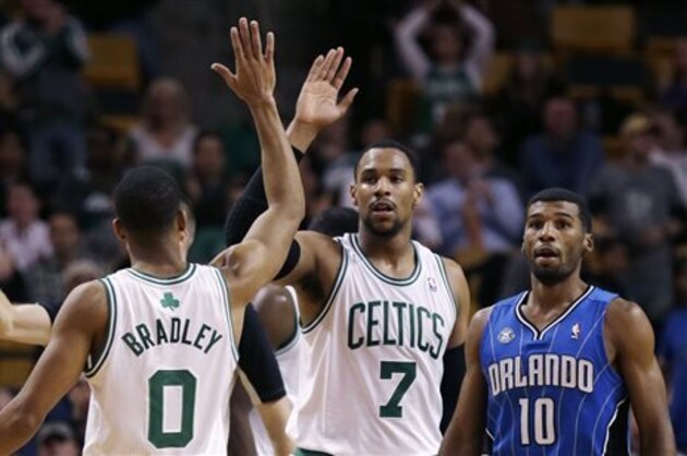 Boston Celtics forward Jared Sullinger (7) and guard Avery Bradley celebrate a point against the Orlando Magic during the second half of an NBA basketball game, in Boston, Monday, Nov. 11, 2013. The Celtics defeated the Magic 120-105. At right is Orlando Magic point guard Ronnie Price (10). (AP Photo/Charles Krupa)