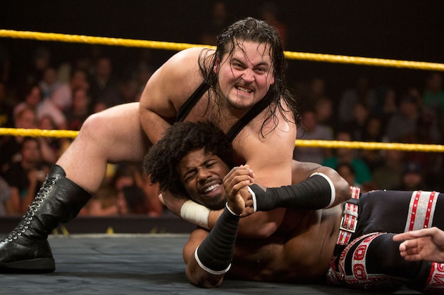 Bull Dempsey clamps down on Xavier Woods.