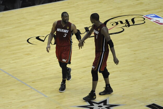 Jun 5, 2014; San Antonio, TX, USA; Miami Heat guard Dwyane Wade (3) talks with forward Chris Bosh (1) after a timeout in the second half against the San Antonio Spurs in game one of the 2014 NBA Finals at AT&T Center. Mandatory Credit: Brendan Maloney-USA TODAY Sports