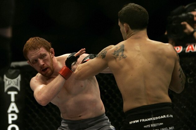 Frank Edgar (right) and Mark Bocek exchange punches at Ultimate Fighting Championship 73 on Saturday, July 7, 2007, in Sacramento, Calif.  Edgar won via 1st round TKO by strikes. (AP Photo/Jeff Chiu)