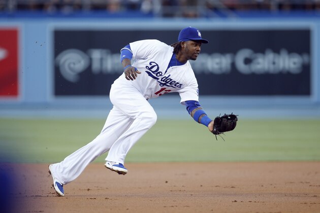 Los Angeles Dodgers shortstop Hanley Ramirez fields a ground ball hit by Los Angeles Angels Howie Kendrick but commits a throwing error allowing Erick Aybar to score during the first inning of a baseball game, Monday, August 4, 2014, in Los Angeles. (AP Photo/Danny Moloshok)
