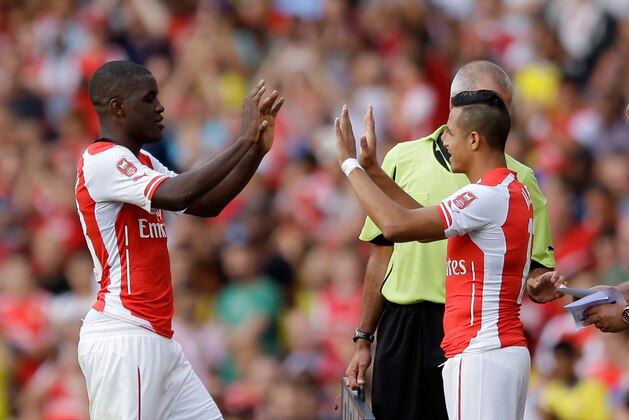 Arsenal's Joel Campbell, left, is substituted on his debut for fellow debutant Alexis Sanchez, during the Emirates Cup soccer match between between Arsenal and Benfica at Arsenal's Emirates Stadium in London, Saturday, Aug. 2, 2014.  (AP Photo/Matt Dunham)