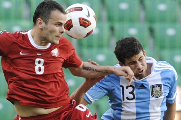 Argentina's Mateo Musacchio, right, fights for the ball with Poland's Pawel Brozek during their friendly soccer match in Warsaw, Poland, Sunday, June 5, 2011. (AP Photo/Alik Keplicz)