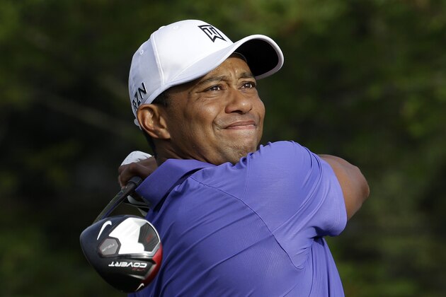 Tiger Woods watches his tee shot on the 10th hole during the first round of the PGA Championship golf tournament at Valhalla Golf Club on Thursday, Aug. 7, 2014, in Louisville, Ky. (AP Photo/John Locher)