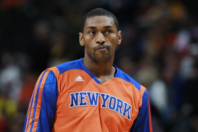 New York Knicks forward Metta World Peace warms up before facing the Denver Nuggets in the first quarter of an NBA basketball game in Denver on Friday, Nov. 29, 2013. (AP Photo/David Zalubowski)