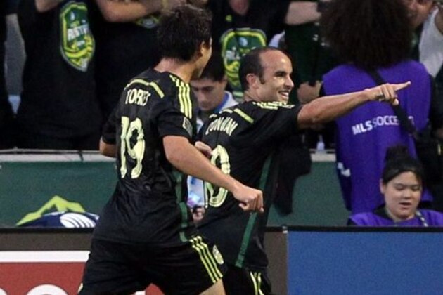 Aug 6, 2014; Portland, OR, USA; MLS All Stars midfielder Landon Donovan (10) of the Los Angeles Galaxy is congratulated by teammates after scoring a goal against Bayern Munich in the second half during the 2014 MLS All Star Game at Providence Park. Mandatory Credit: Jaime Valdez-USA TODAY Sports