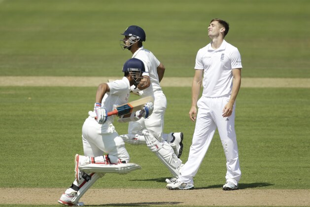 India's Ajinkya Rahane, left, and Virat Kohli add runs off a England's Chris Woakes, delivery during the third day of the third cricket test match of the series between England and India at The Ageas Bowl in Southampton, England, Tuesday, July 29, 2014.  (AP Photo/Matt Dunham)