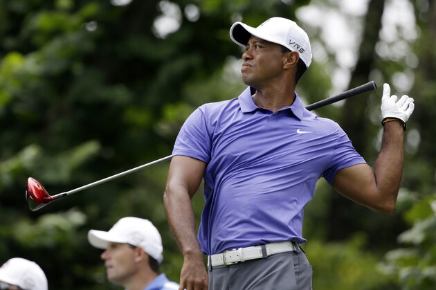 Tiger Woods reacts to a poor tee shot on the seventh hole during the first round of the PGA Championship golf tournament at Valhalla Golf Club on Thursday, Aug. 7, 2014, in Louisville, Ky. (AP Photo/John Locher)
