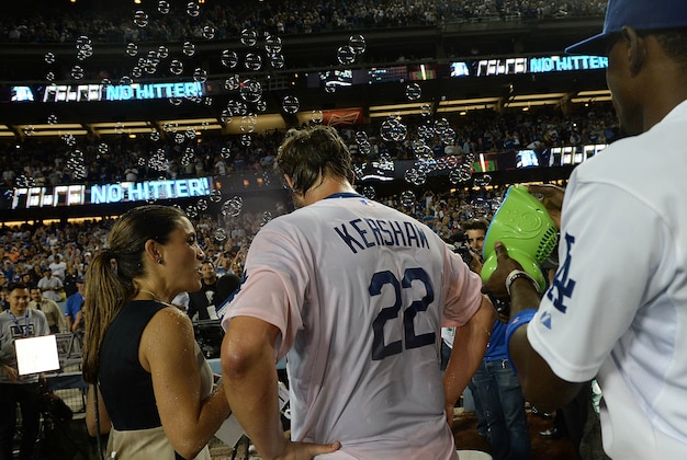 Jun 18, 2014; Los Angeles, CA, USA;    Los Angeles Dodgers second baseman Dee Gordon (9) blows bubbles on starting pitcher Clayton Kershaw (22) as he is interviewed on TV after pitching a no hitter against the Colorado Rockies at Dodger Stadium. Dodgers won 8-0.Mandatory Credit: Jayne Kamin-Oncea-USA TODAY Sports