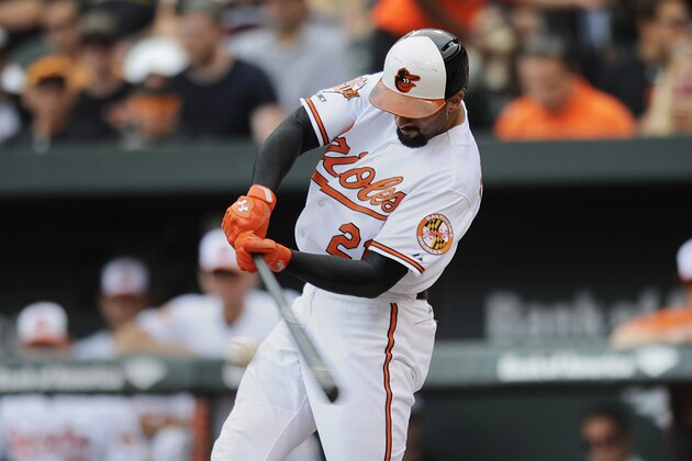 Baltimore Orioles' Nick Markakis connects for a single against the Seattle Mariners in the third inning of a baseball game Sunday, Aug.  3, 2014, in Baltimore. (AP Photo/Gail Burton)