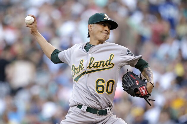 Oakland Athletics starting pitcher Jesse Chavez throws against the Seattle Mariners in the second inning of a baseball game Saturday, July 12, 2014, in Seattle. (AP Photo/Elaine Thompson)