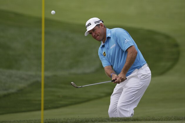 Lee Westwood, of England, hits a chip on the first hole during the first round of the PGA Championship golf tournament at Valhalla Golf Club on Thursday, Aug. 7, 2014, in Louisville, Ky. (AP Photo/David J. Phillip)