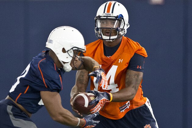 Auburn quarterback Nick Marshall, right, runs drills with running back Corey Grant during NCAA college football practice Friday, Aug. 1, 2014, in Auburn, Ala. (AP Photo/Brynn Anderson)