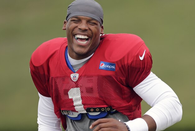 Carolina Panthers' Cam Newton laughs as he runs up the field during an NFL football practice at their training camp in Spartanburg, S.C., Friday, Aug. 1, 2014. (AP Photo/Chuck Burton)