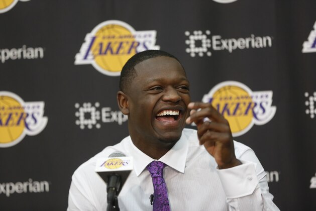 Former Kentucky forward Julius Randle smiles as he is introduced as the newest Los Angeles Laker by General Manager Mitch Kupchak, not seen, Monday, June 30, 2014 in El Segundo, Calif. Former Kentucky forward Julius Randle was selected seventh overall by the Lakers during the 2014 NBA draft. (AP Photo/Damian Dovarganes)