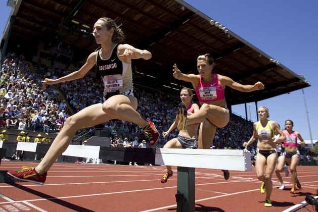 Jennifer Barringer leads the pack over a hurdle in the 3,000-meter steeplechase at Hayward Field during the U.S. track and field championships in Eugene, Ore., Sunday, June 28, 2009. Barringer won the event. (AP Photo/Don Ryan)