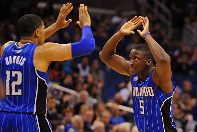 Mar 28, 2014; Orlando, FL, USA; Orlando Magic guard Victor Oladipo (5) and forward Tobias Harris (12) celebrate after Harris drew a foul in overtime as the Magic beat the Charlotte Bobcats 110-105 at Amway Center. Mandatory Credit: David Manning-USA TODAY Sports