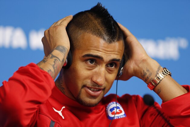 Arturo Vidal of Chile adjusts his headphones during a press conference at the Itaquerao Stadium in Sao Paulo, Brazil, Sunday, June 22, 2014. Chile will play Netherlands in a match that will decide the winner of Group B at the 2014 soccer World Cup. (AP Photo/Wong Maye-E)