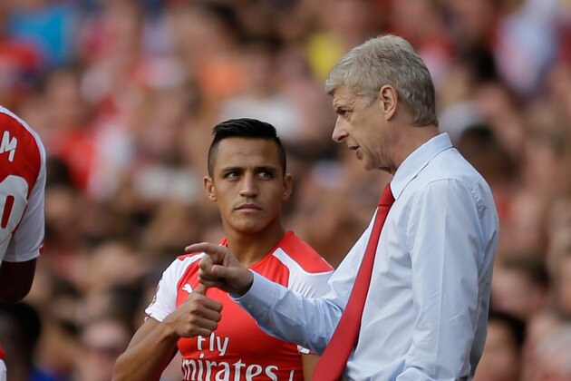 Arsenal's French manager Arsene Wenger, right, gives instructions to his new signing Alexis Sanchez as he substituted on to make his debut, during the Emirates Cup soccer match between between Arsenal and Benfica at Arsenal's Emirates Stadium in London, Saturday, Aug. 2, 2014.  (AP Photo/Matt Dunham)