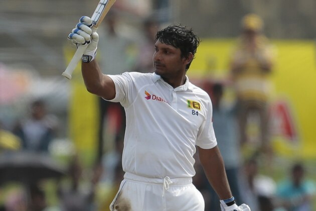 Sri Lankan batsman Kumar Sangakkara acknowledges the crowd after scoring a century during the third day of the first test cricket match between Sri Lanka and Pakistan in Galle, Sri Lanka, Friday, Aug. 8, 2014. (AP Photo/Eranga Jayawardena)
