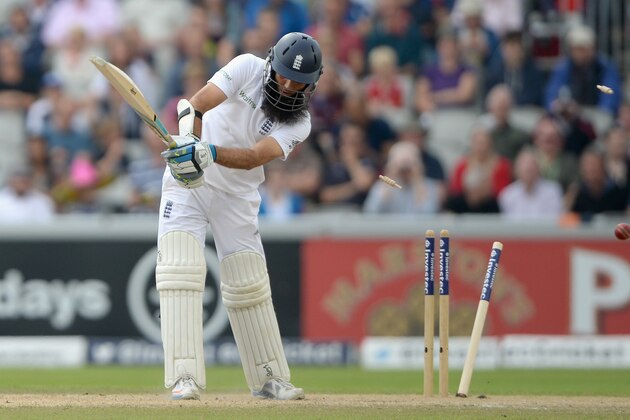 MANCHESTER, ENGLAND - AUGUST 08:  Moeen Ali of England is bowled by Varun Aaron of India during day two of 4th Investec Test match between England and India at Old Trafford on August 8, 2014 in Manchester, England.  (Photo by Gareth Copley/Getty Images)