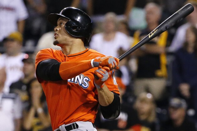 Miami Marlins' Giancarlo Stanton hits a two-run home run off Pittsburgh Pirates relief pitcher Stolmy Pimentel during the ninth inning of a baseball game in Pittsburgh Thursday, Aug. 7, 2014. The Pirates won 7-2. (AP Photo/Gene J. Puskar)