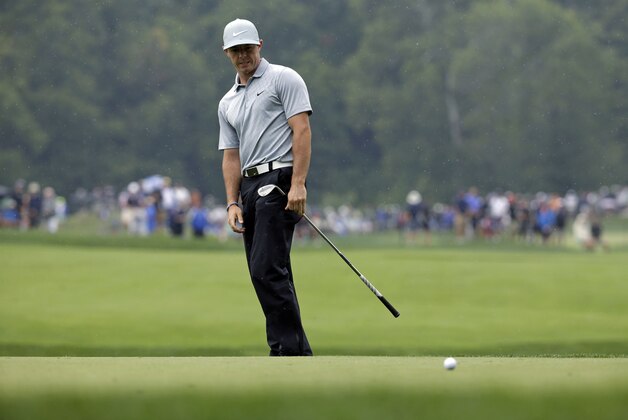 Rory McIlroy, of Northern Ireland, reacts after his chip to the fourth green during the second round of the PGA Championship golf tournament at Valhalla Golf Club on Friday, Aug. 8, 2014, in Louisville, Ky. (AP Photo/John Locher)