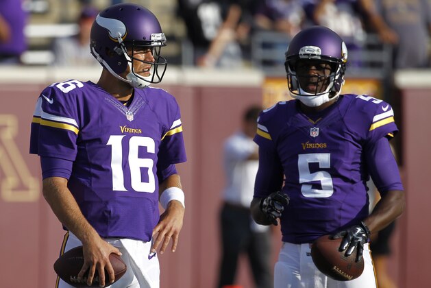 Minnesota Vikings quarterback Matt Cassel (16) and Minnesota Vikings quarterback Teddy Bridgewater (5) wait to throw before a exhibition NFL football game at TCF Bank Stadium in Minneapolis, Friday, Aug. 8, 2014.  (AP Photo/Ann Heisenfelt)