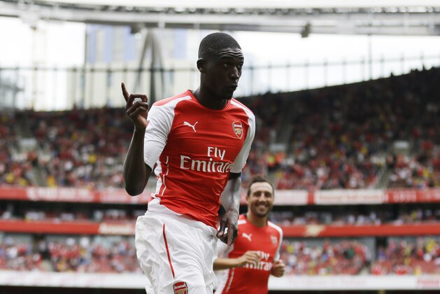 Arsenal's Yaya Sanogo celebrates scoring his fourth goal during the Emirates Cup soccer match between between Arsenal and Benfica at Arsenal's Emirates Stadium in London, Saturday, Aug. 2, 2014.  (AP Photo/Matt Dunham)